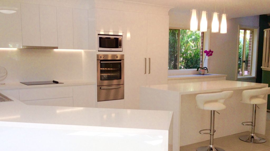 Timeless white kitchen with quartz benchtops, polyurethane cabinets and glass splashback - bathroom renovation by Master Bathrooms & Kitchens