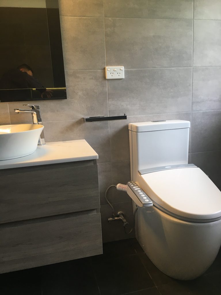 Electric bidet toilet seat providing the ultimate in luxury and hygiene - bathroom renovation by Master Bathrooms & Kitchens.