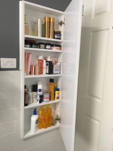 Behind door recessed cabinet for extra storage
