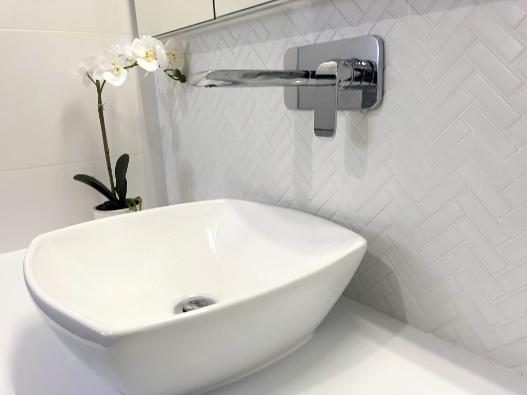 Gorgeous white herringbone tile adds character to this ensuite - bathroom renovation by Master Bathrooms & Kitchens.