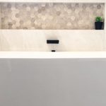 Gorgeous white wall faced free standing bath with decorative niche