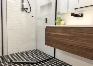 Marble mosaic feature floor, wall hung vanity with custom shaving cabinet and stunning modern, black tapware - bathroom renovation by Master Bathrooms & Kitchens.