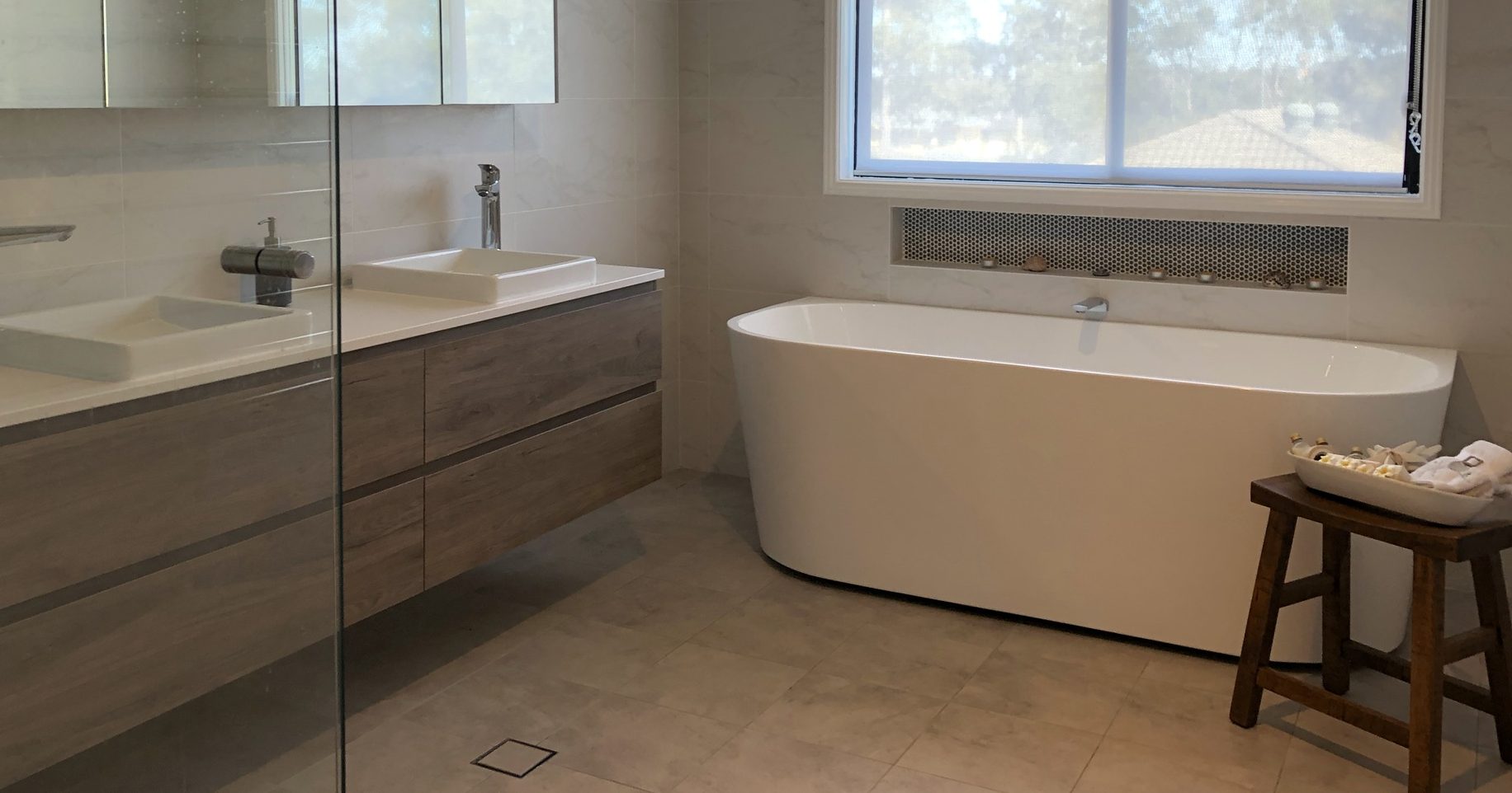 Gorgeous free standing bath with timber wall hung vanity and large mirrored shaving cabinet - Bathroom Renovation by Master Bathrooms & Kitchens