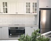 Stunning white shaker cabinets with Caesarstone benchtops and stainless steel appliances - kitchen renovation by Master Bathrooms & Kitchens.