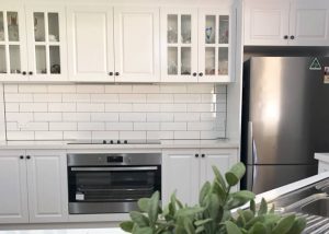 Stunning white shaker cabinets with Caesarstone benchtops and stainless steel appliances - kitchen renovation by Master Bathrooms & Kitchens.