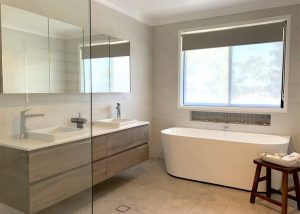 Gorgeous wall hung vanity with large custom made mirrored shaving cabinet. Bathroom renovation by Master Bathrooms & Kitchens.