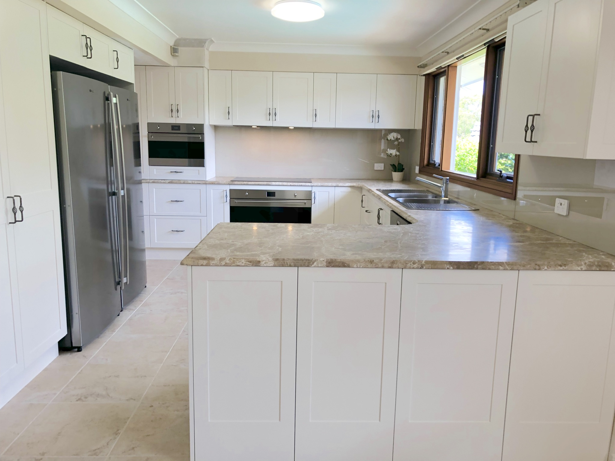 Timeless shaker cabinets with natural marble benchtops - kitchen renovation by Master Bathrooms & Kitchens