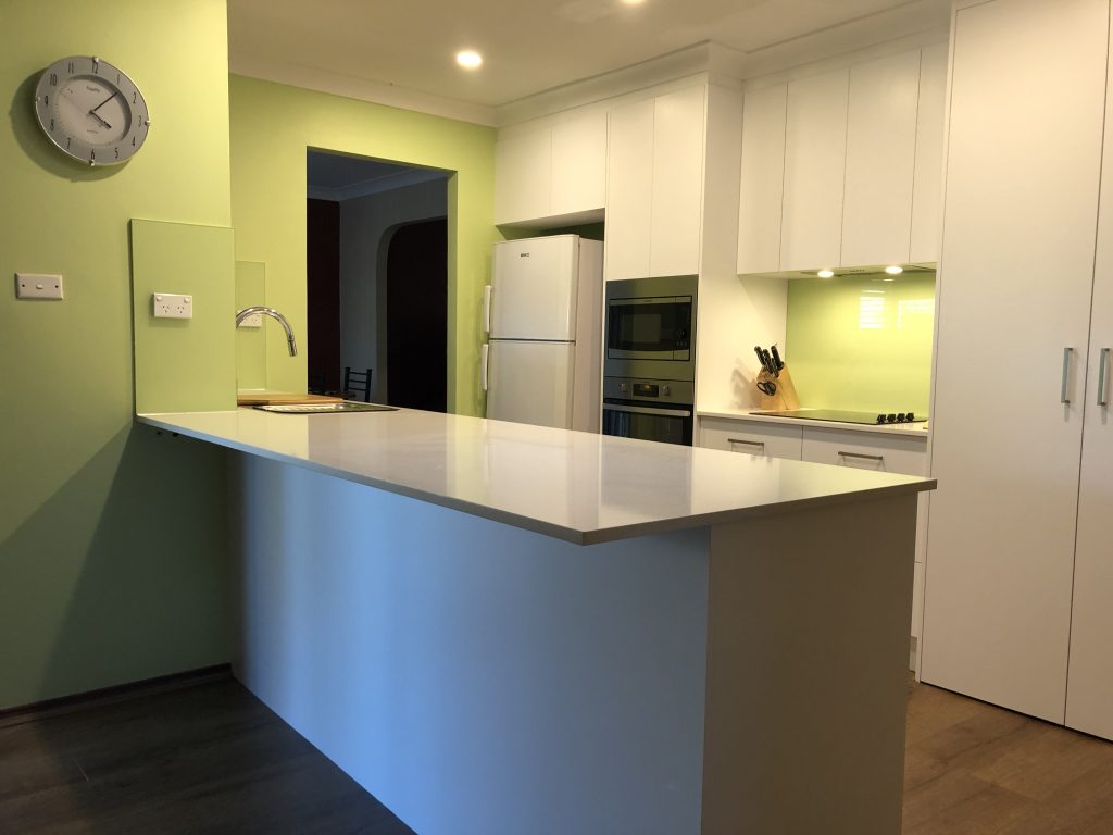 Galley kitchen with tall wall cabinetry to make the most of storage space - kitchen renovation by Master Bathrooms & Kitchens.