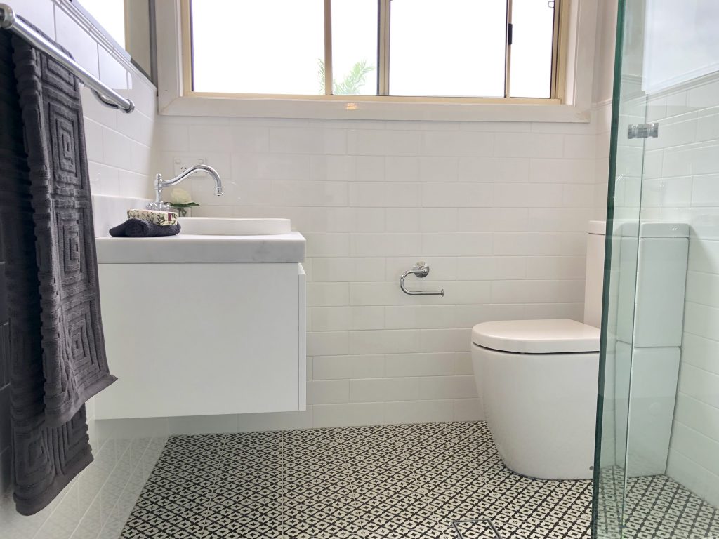 Gorgeous wall hung vanity, antique style tapware & fittings with subway wall tile and feature floor - bathroom renovation by Master Bathrooms & Kitchens.