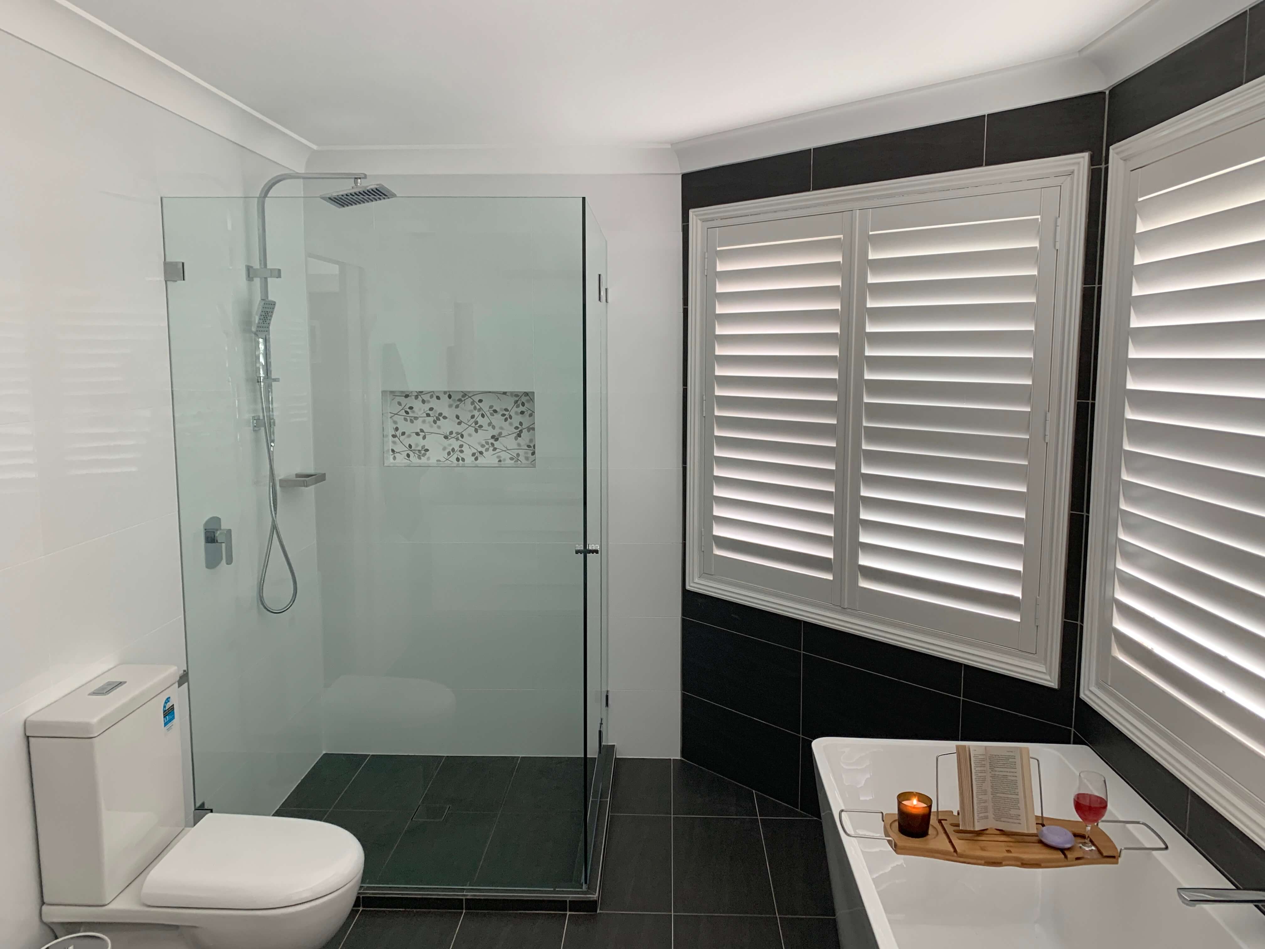 Beautiful shower recess with chrome rail shower, niche & frameless shower screen - bathroom renovation by Master Bathrooms & Kitchens.
